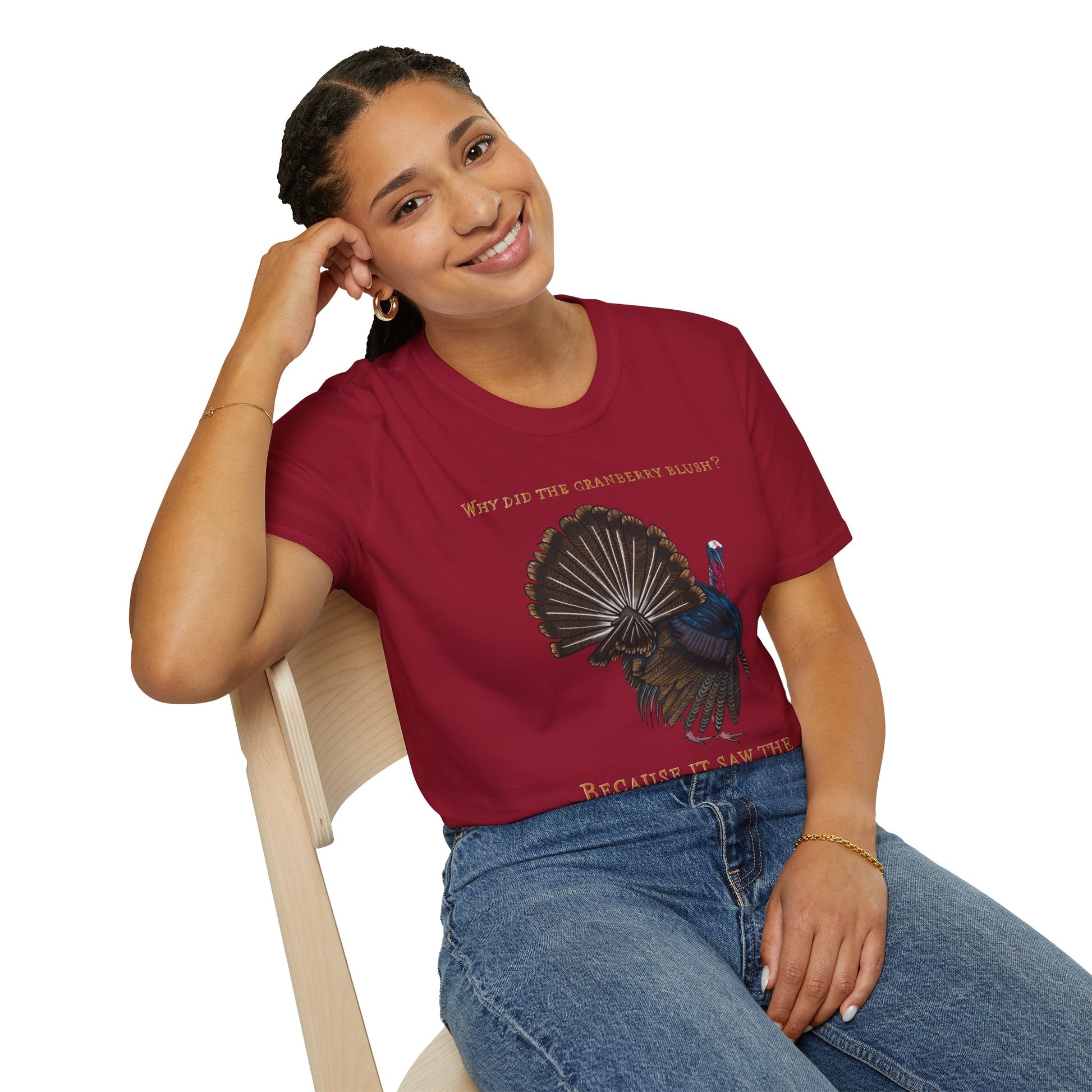 Woman wearing a red Thanksgiving t-shirt featuring a picture of a turkey and the text 'Why did the cranberry blush? Because it saw the turkey dressing!
